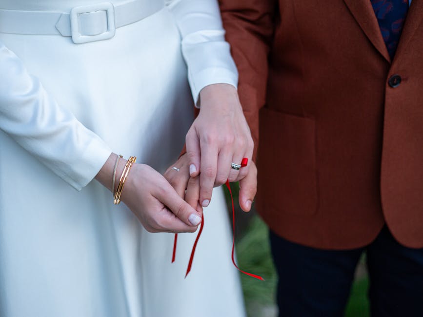 Couple's hands bound with a Celtic handfasting cord during a wedding unity ceremony