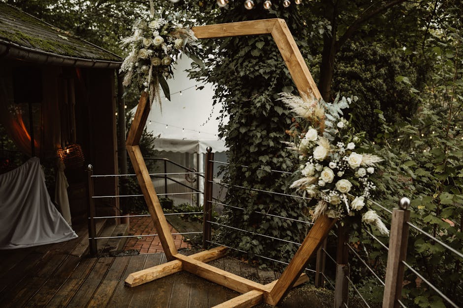 Hexagon wedding ceremony arch ideas with white floral cluster
