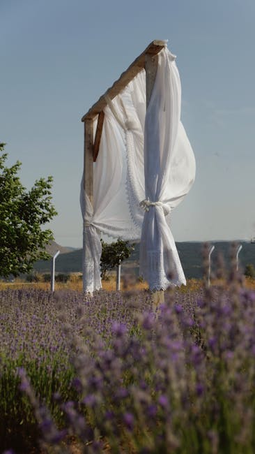 Draped fabric wedding arch ideas with white chiffon swag