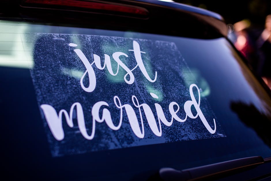 Linen Just Married banner on the back of a white wedding car showing classic wedding car decoration ideas