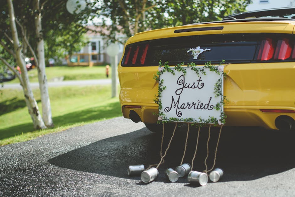 Decorated tin cans on a string trailing from a wedding car bumper as classic wedding car decoration ideas