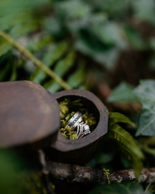 Engraved walnut wooden ring box on moss showing rustic wedding ring box ideas