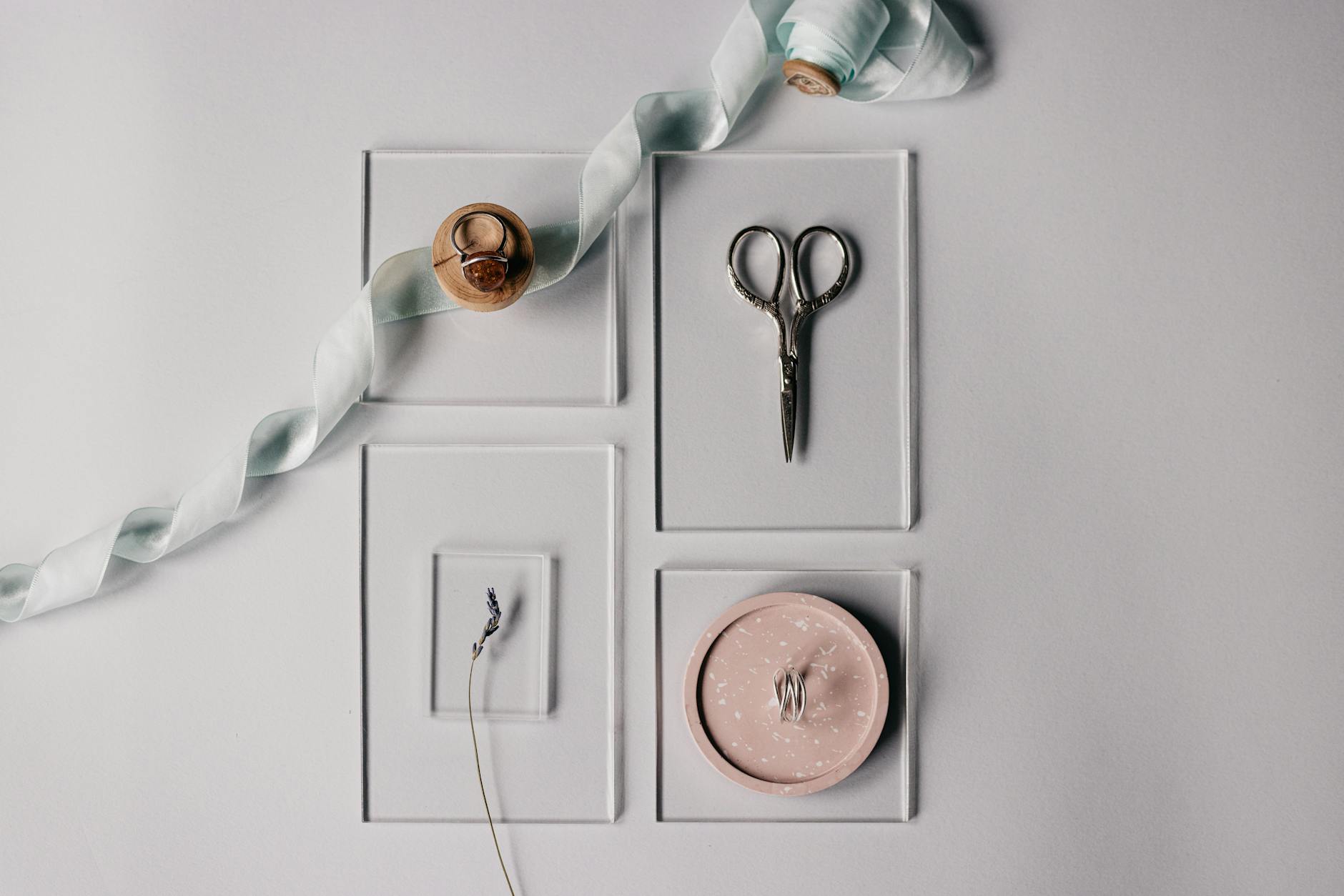 DIY wedding favor tags in progress with cardstock, punch, twine, and craft tools