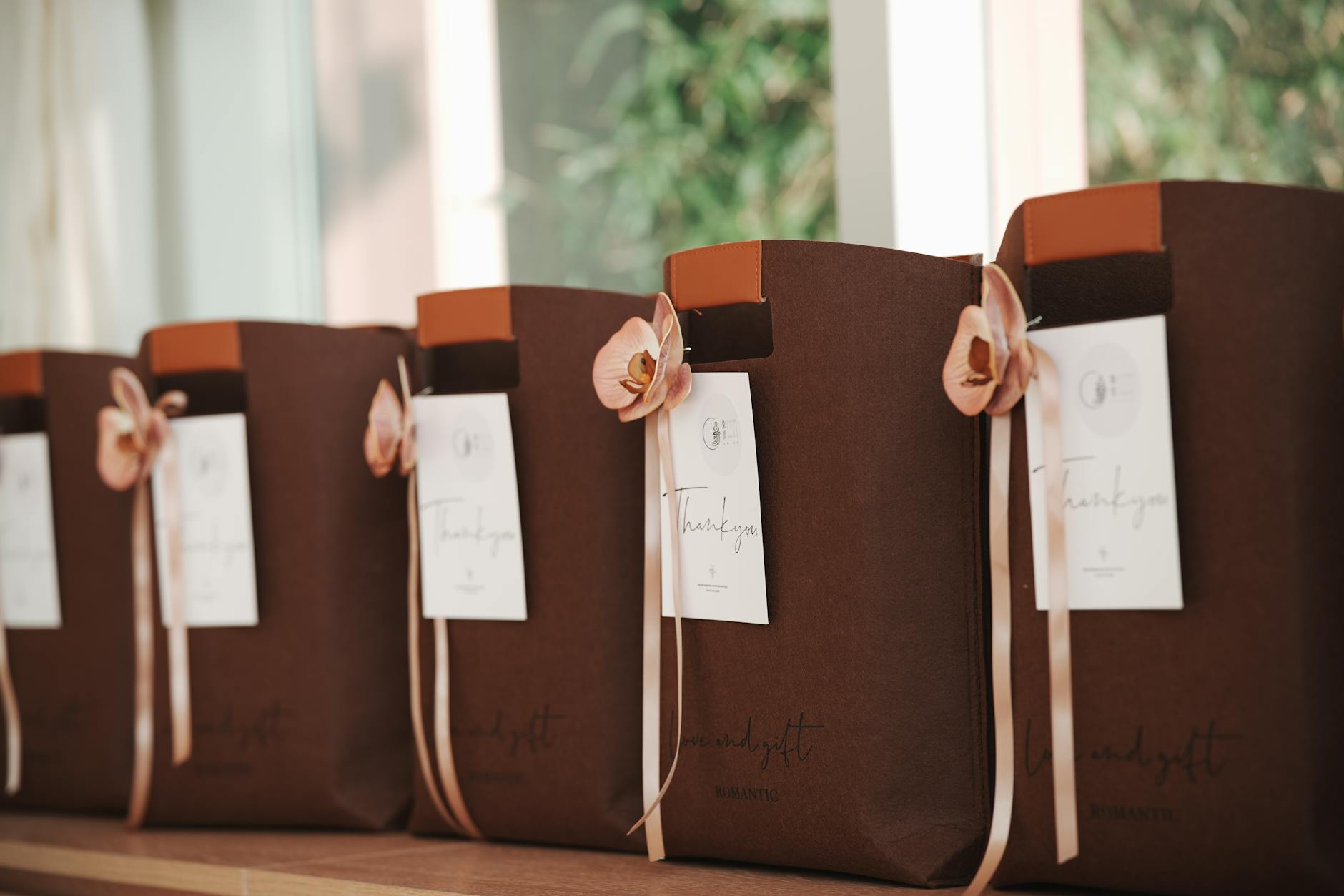 Wedding favor tags tied with silk ribbon, dried lavender, and small sealing wax accents