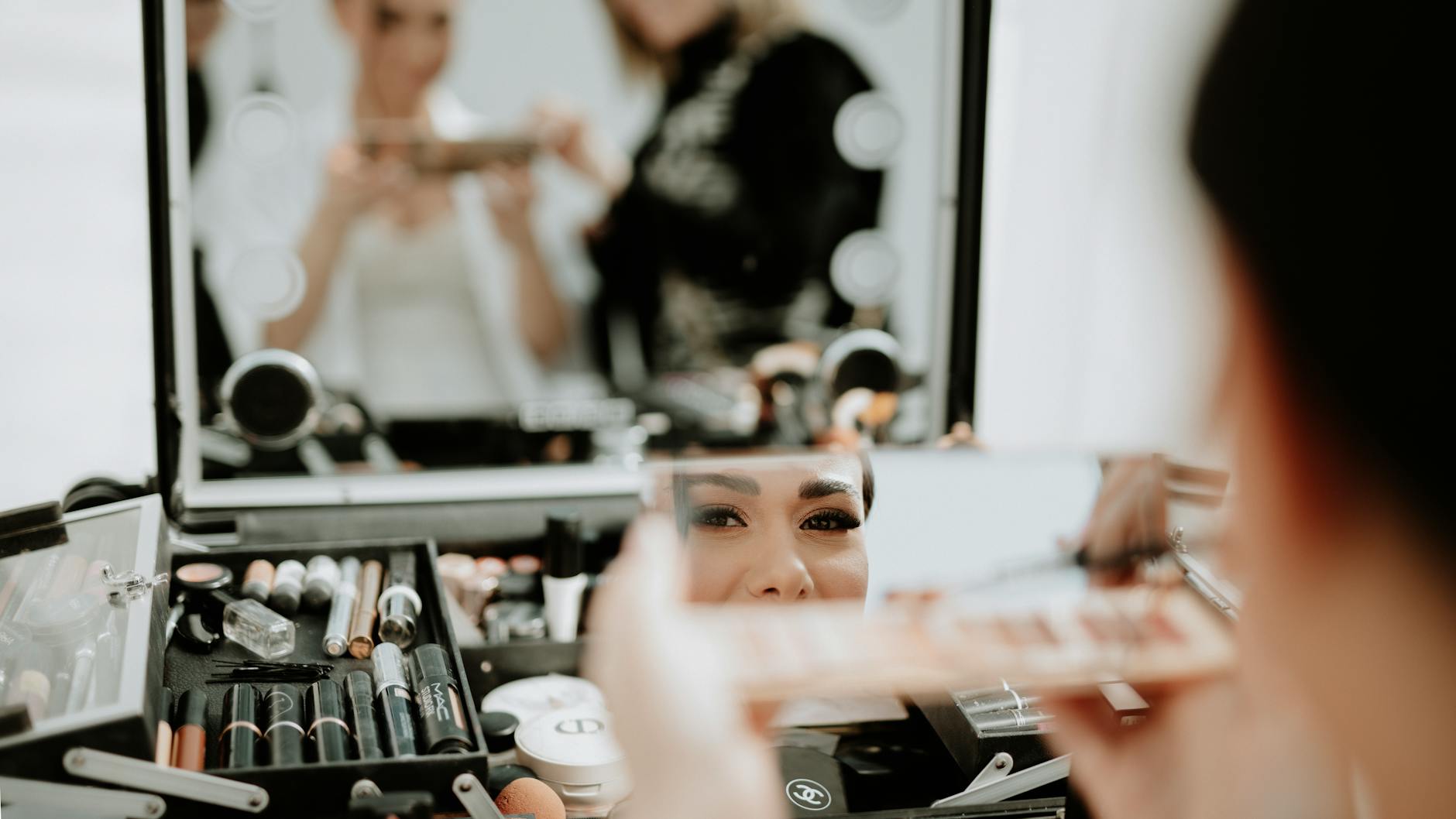 Bridal morning survival kit with makeup brushes, sewing supplies, and emergency essentials on a vanity