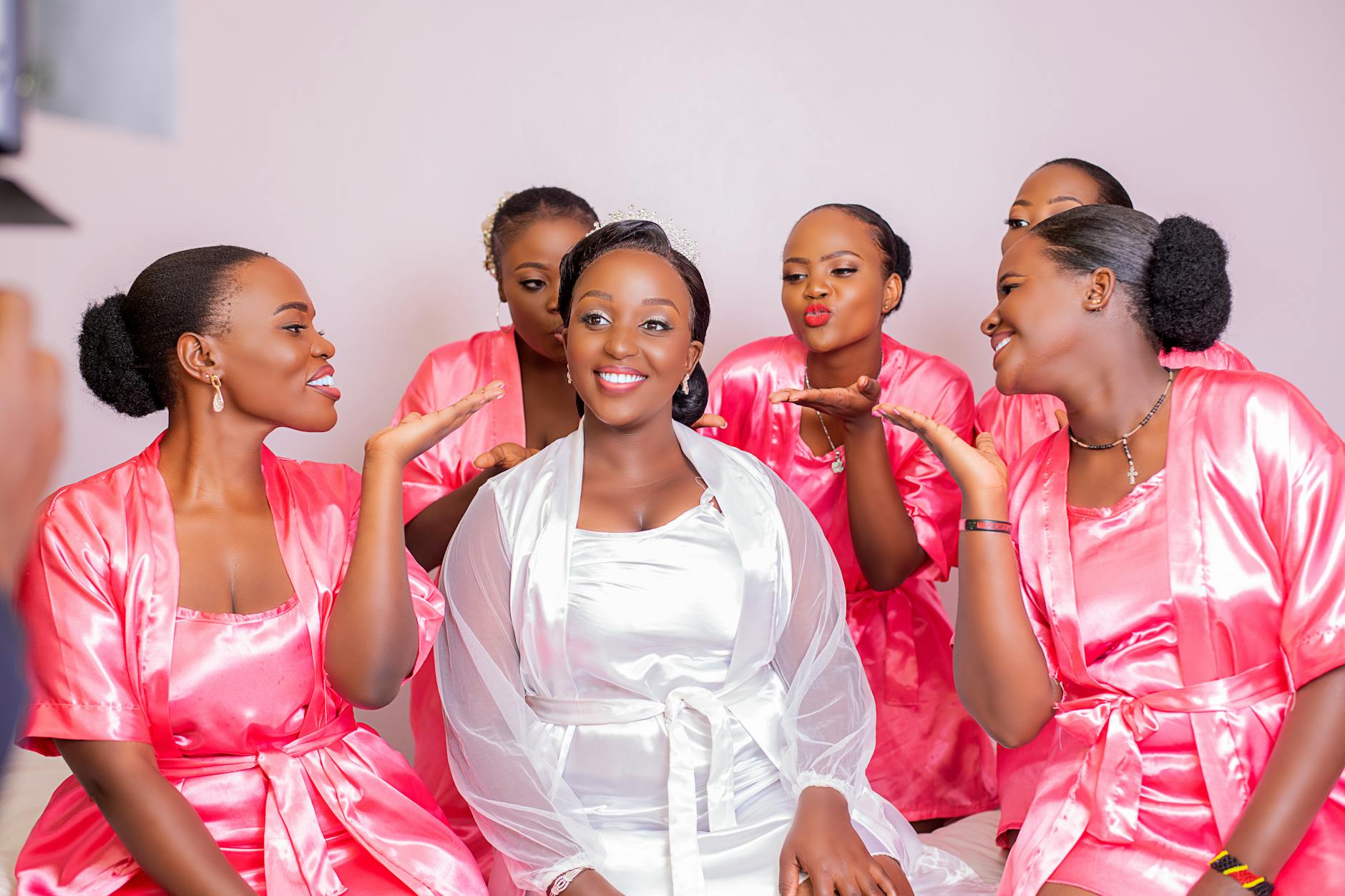 Bride and bridesmaids in matching silk robes during wedding morning getting ready