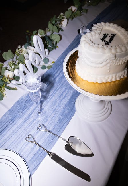 Classic engraved silver wedding cake cutting set displayed on white linen