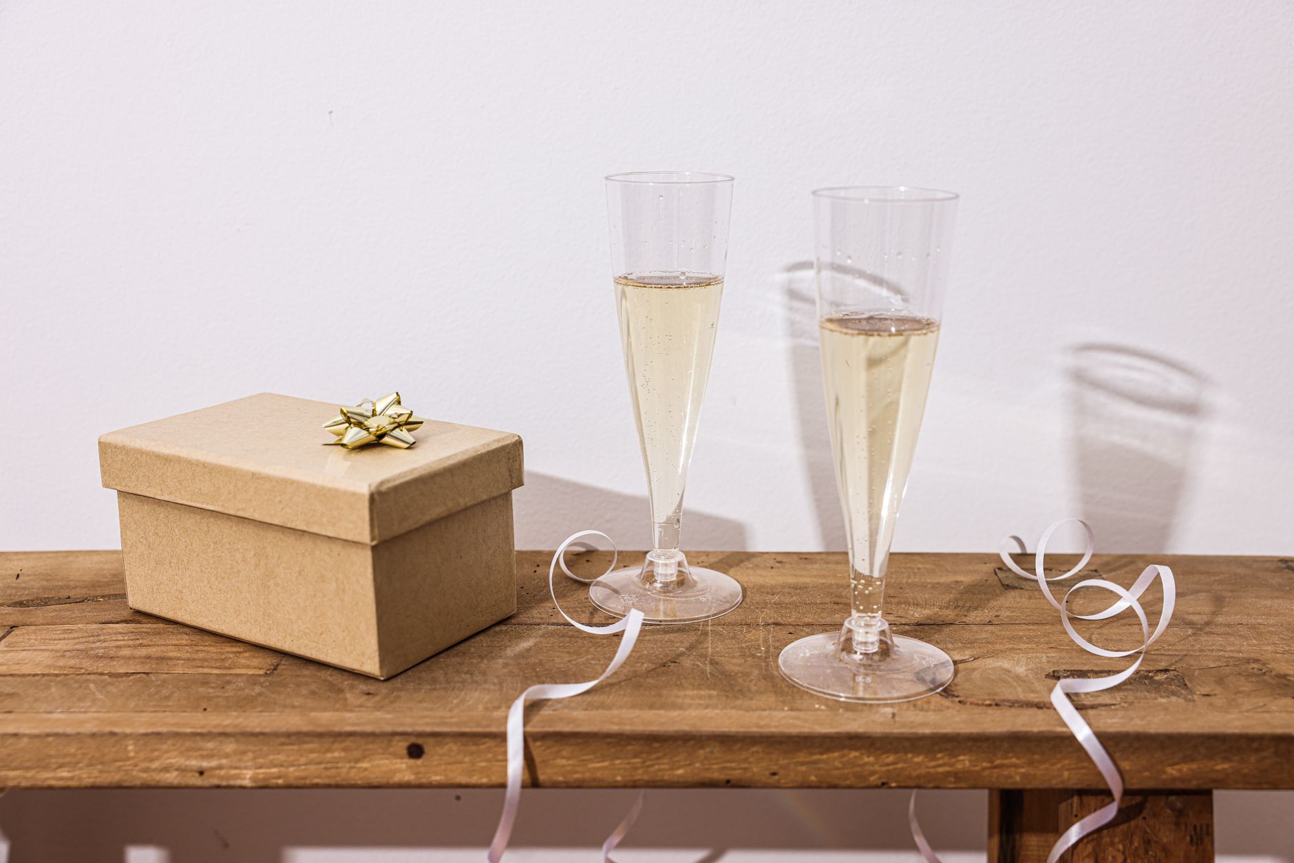 Modern minimalist wedding toasting glasses on a marble reception table