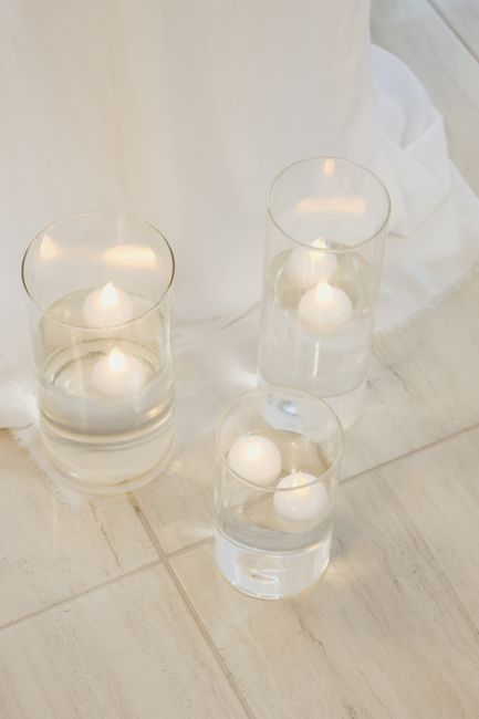 Floating candle centerpiece ideas glowing on a reception table