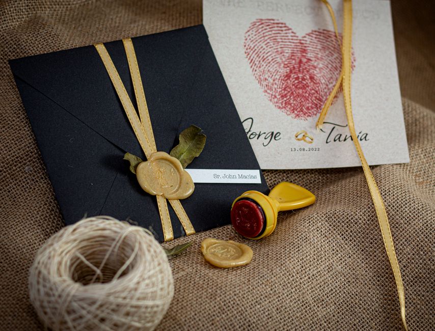 Wax-sealed wedding program idea with wooden stamp and ribbon tie