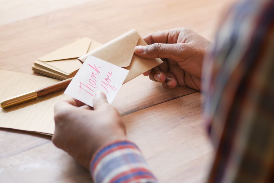 Handwritten thank you note card for a wedding vendor alongside a tip envelope