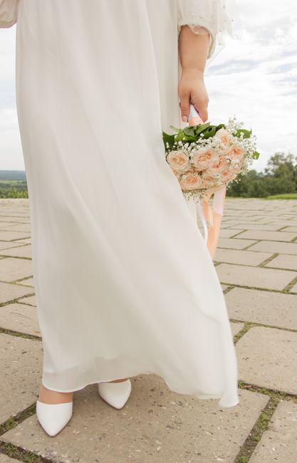Cushioned bridal ballet flats worn under a wedding dress