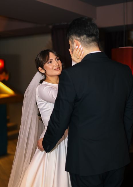 Two tier detachable wedding veil idea being removed before a reception
