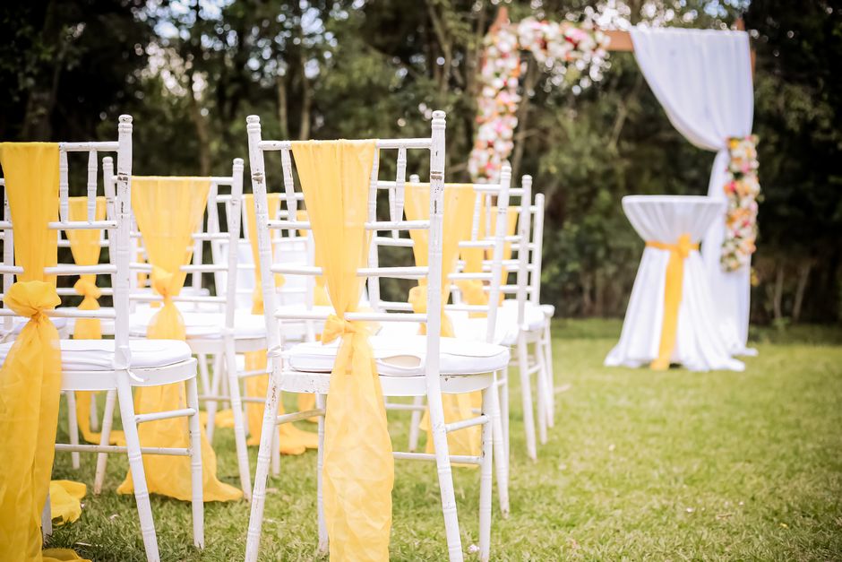 Gold satin wedding chair sashes tied in bows on reception chairs