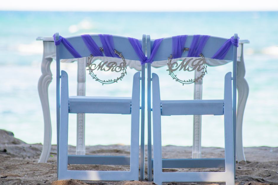 Mr and Mrs hexagon wood chair signs hanging on wedding reception chairs