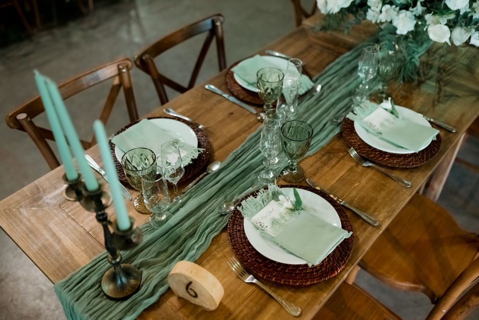 Cheesecloth wedding table runner on a rustic farm table