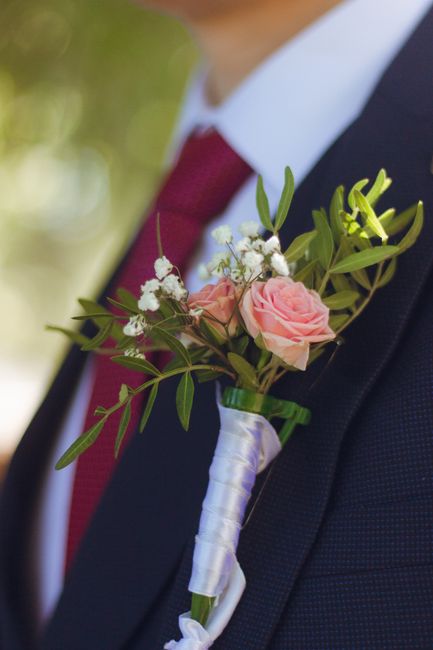 Red silk rose wedding boutonniere with greenery and ribbon wrap