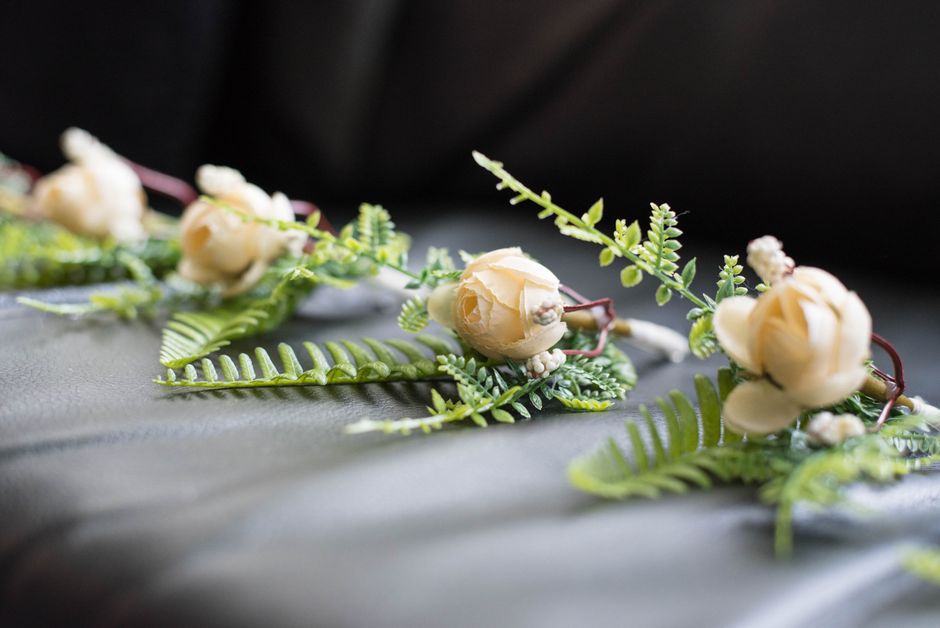 White silk rose boutonniere for a wedding party
