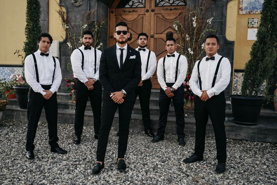 Groomsmen wearing matching silk boutonnieres before a wedding