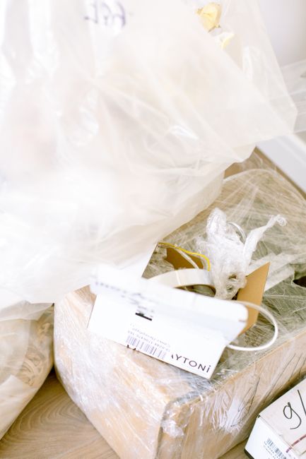 Clear plastic storage boxes protecting wedding boutonnieres