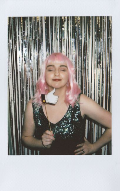 Photo booth backdrop stand set up with sequin curtain at a wedding reception