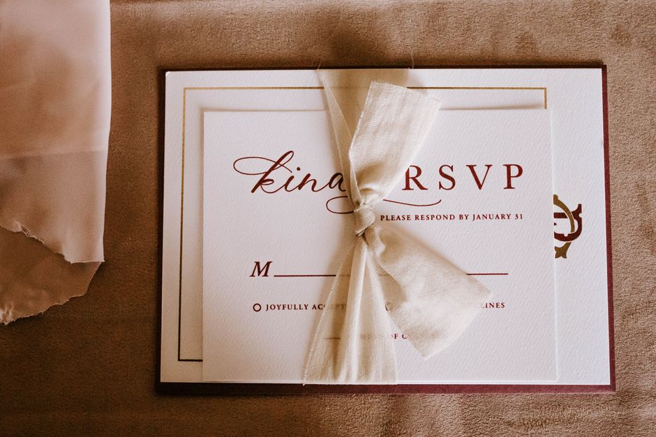 Translucent vellum wrap tied around wedding invitation suite