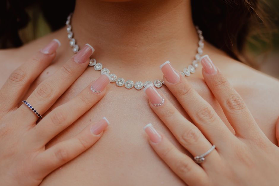Macro photo of rhinestone-embellished bridal nail art