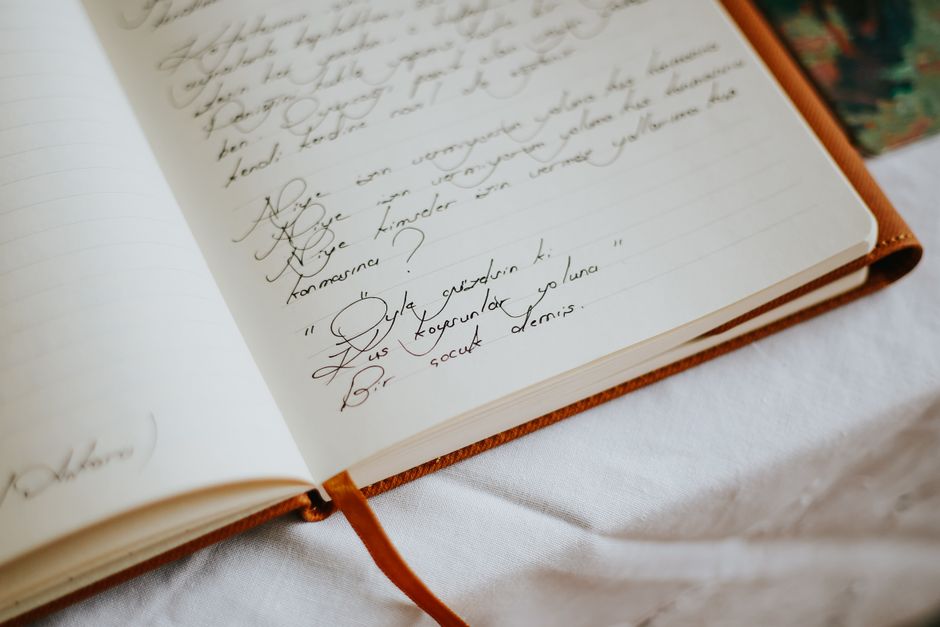 Leather journal used to draft a wedding rehearsal dinner welcome speech