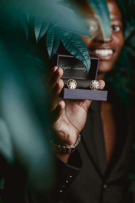 Engraved personalized cufflinks displayed in a wooden gift box for a groom