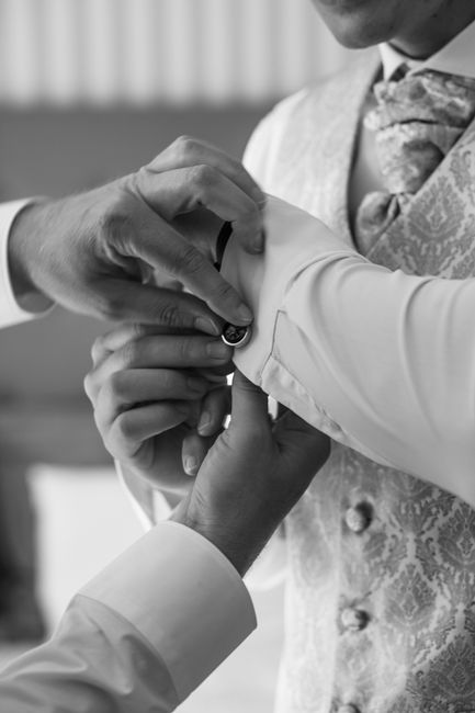 Groomsmen wearing matching cufflinks as part of coordinated wedding party attire