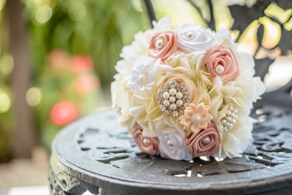 Rhinestone brooch pins tucked into a bridal bouquet