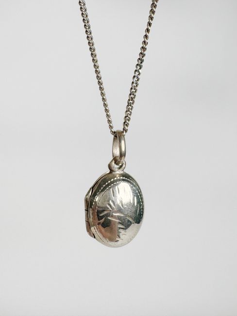 Memorial photo locket charm attached to a wedding bouquet