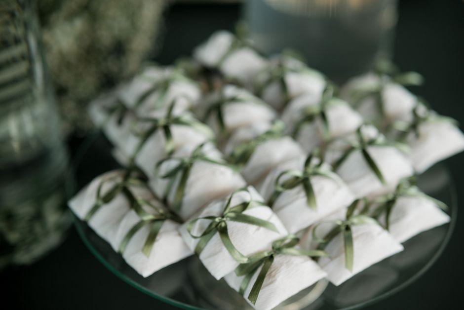 Ribbon-tied favor gift boxes arranged on a bridal shower table, an example of finished favor packaging
