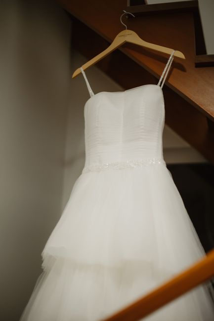 Satin padded hanger supporting a wedding dress with beaded straps