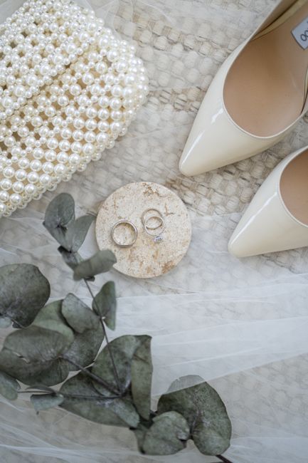 Wedding guest accessories including a satin clutch and block heel sandals