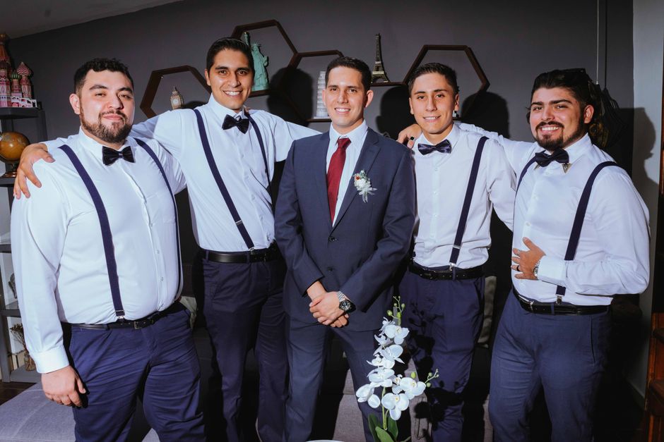 Groomsmen in bow ties and suspenders, an alternative to traditional groomsmen tie ideas