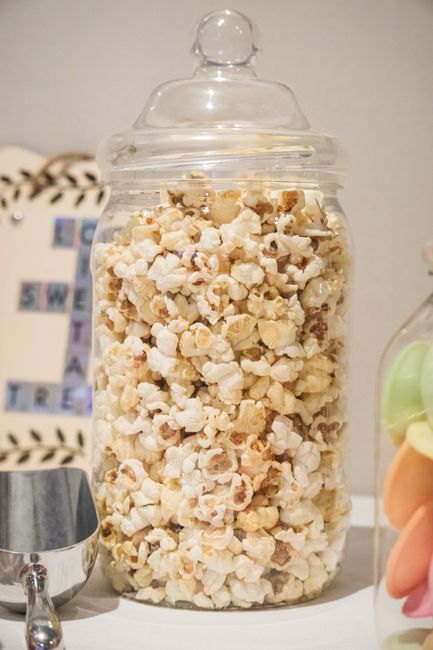 Gold candy scoops for a wedding candy buffet next to glass jars