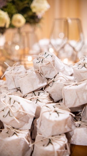 Take-home favor bags for a wedding candy buffet stacked on a table