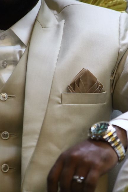Olive green silk pocket square paired with a suit for an outdoor rustic wedding, showing 2026 earth tone trends