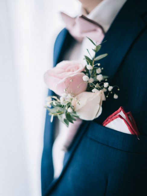 Groomsmen lineup wearing matching navy pocket squares as an example of coordinated wedding party style