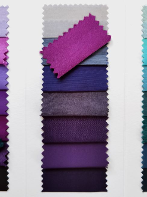 Wedding color palette swatches in blush and purple next to a suit fabric sample for pocket square matching