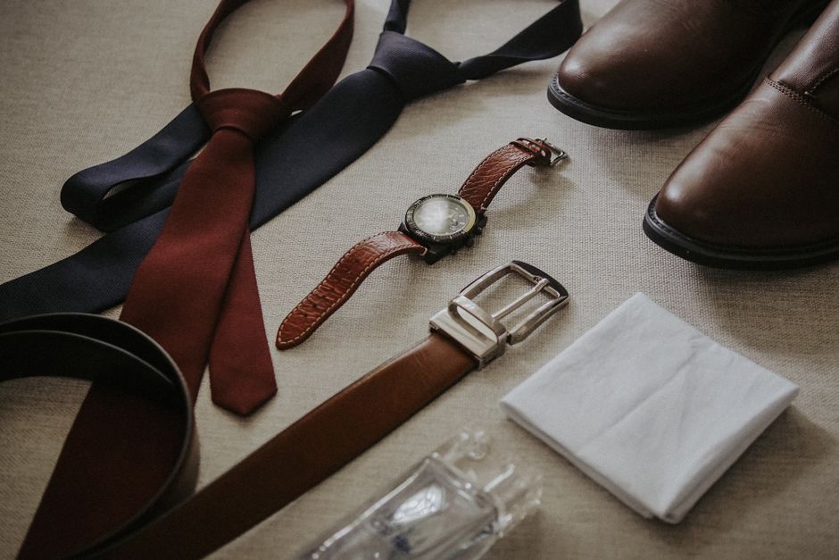 Wedding guest accessories including a silk tie, pocket square, and cufflinks