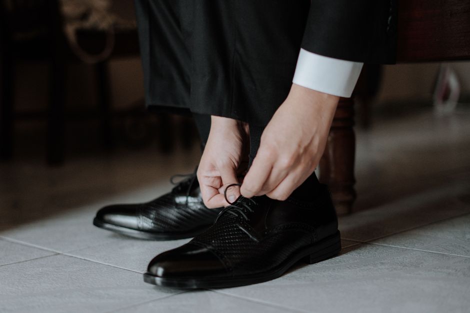 Close-up of polished oxford dress shoes with a formal suit at a wedding