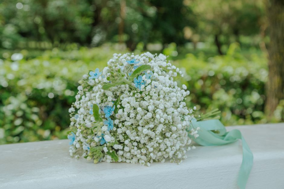 Memorial bouquet charm locket clipped to a bridal bouquet