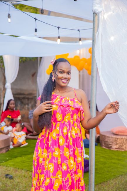 Engagement party outfit ideas showing a bride-to-be in a floral maxi dress