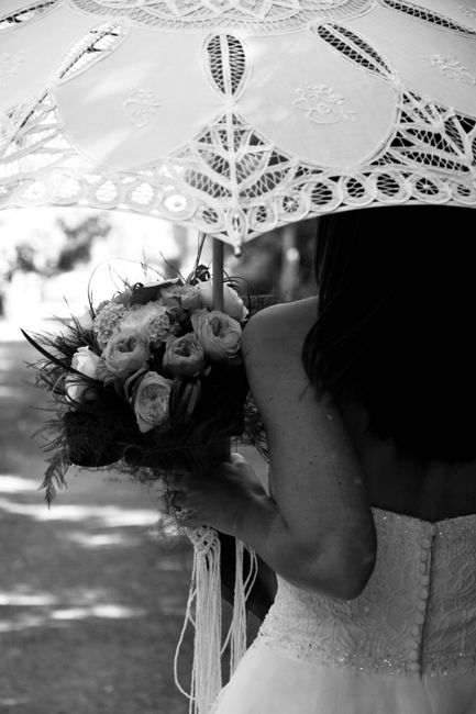 bride with a white lace parasol for wedding portraits