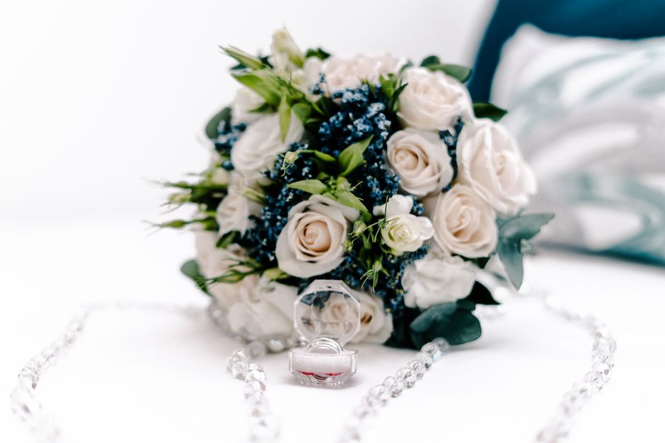 Something blue bouquet charm attached to a bridal bouquet