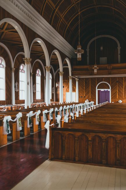 Eucalyptus garland draped along wedding church pews