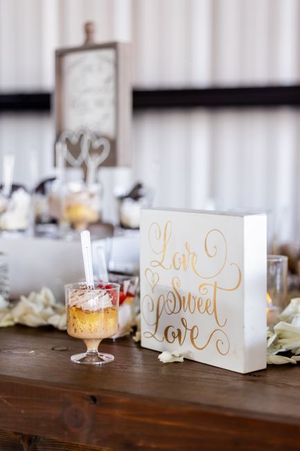 Matching acrylic wedding signs on a reception dessert table
