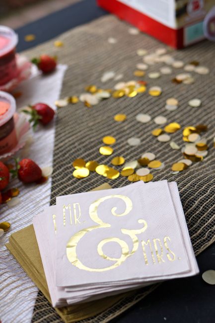Gold foil Mr and Mrs wedding cocktail napkins on a reception table